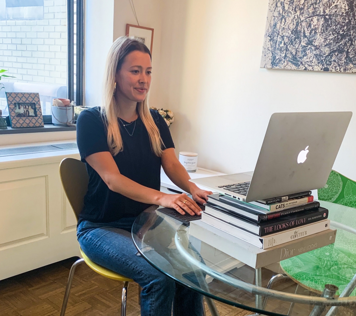 NYC occupational therapist sitting at a desk with a proper ergonomic set up