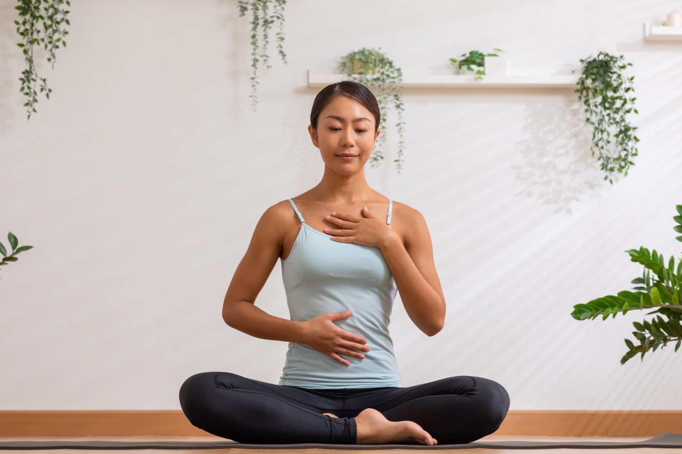 Asian woman doing breathing exercise before practice yoga.Health