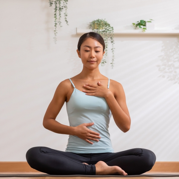 Asian woman doing breathing exercise before practice yoga.Health