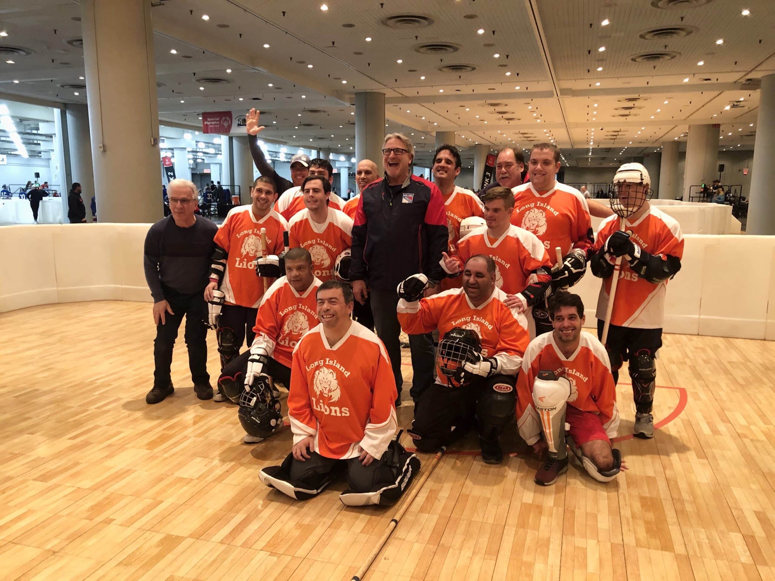 Long Island Lions floor hockey team smiling after a championship game at the Special Olympics