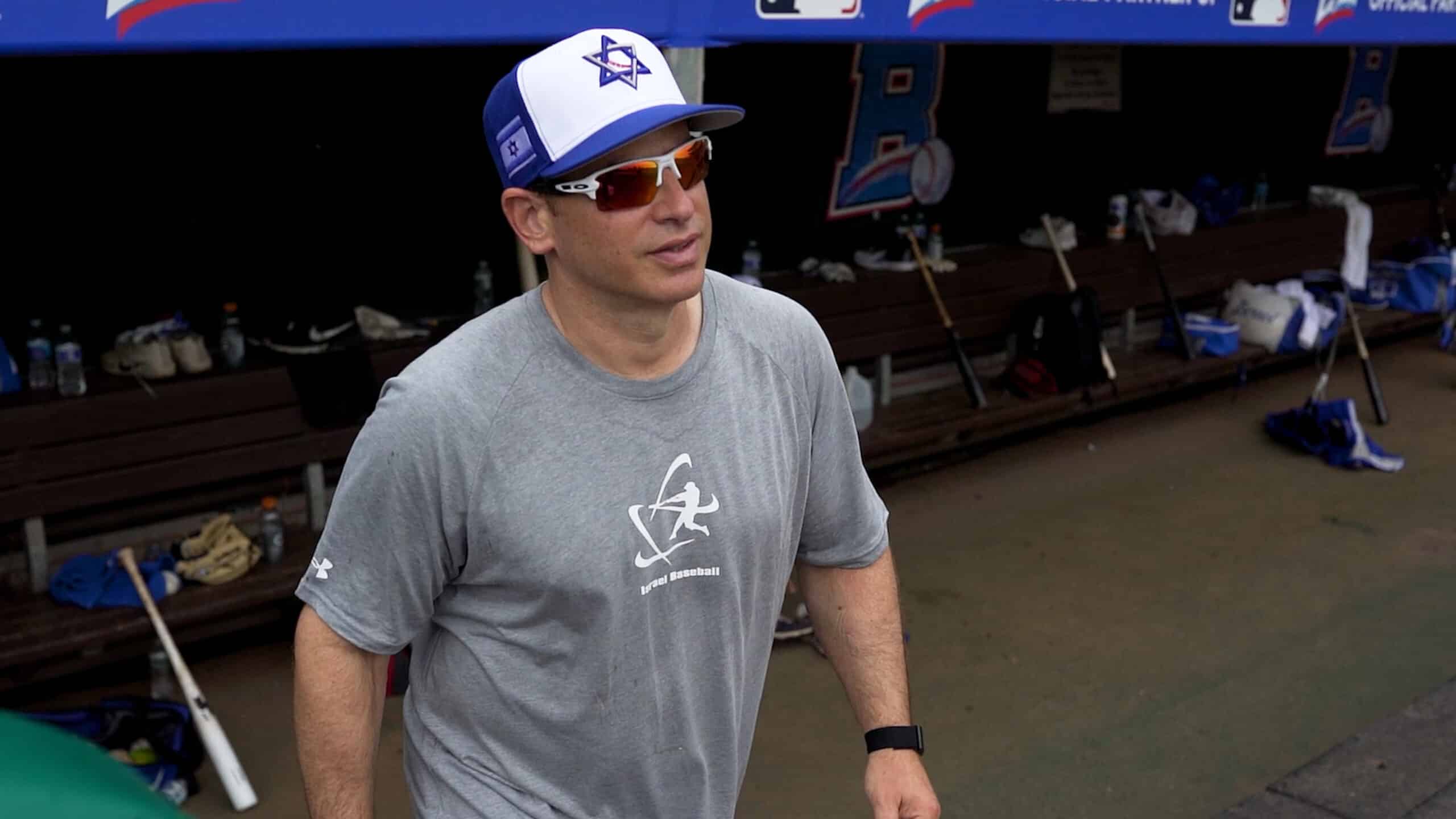 man with a baseball hat on in the dug out