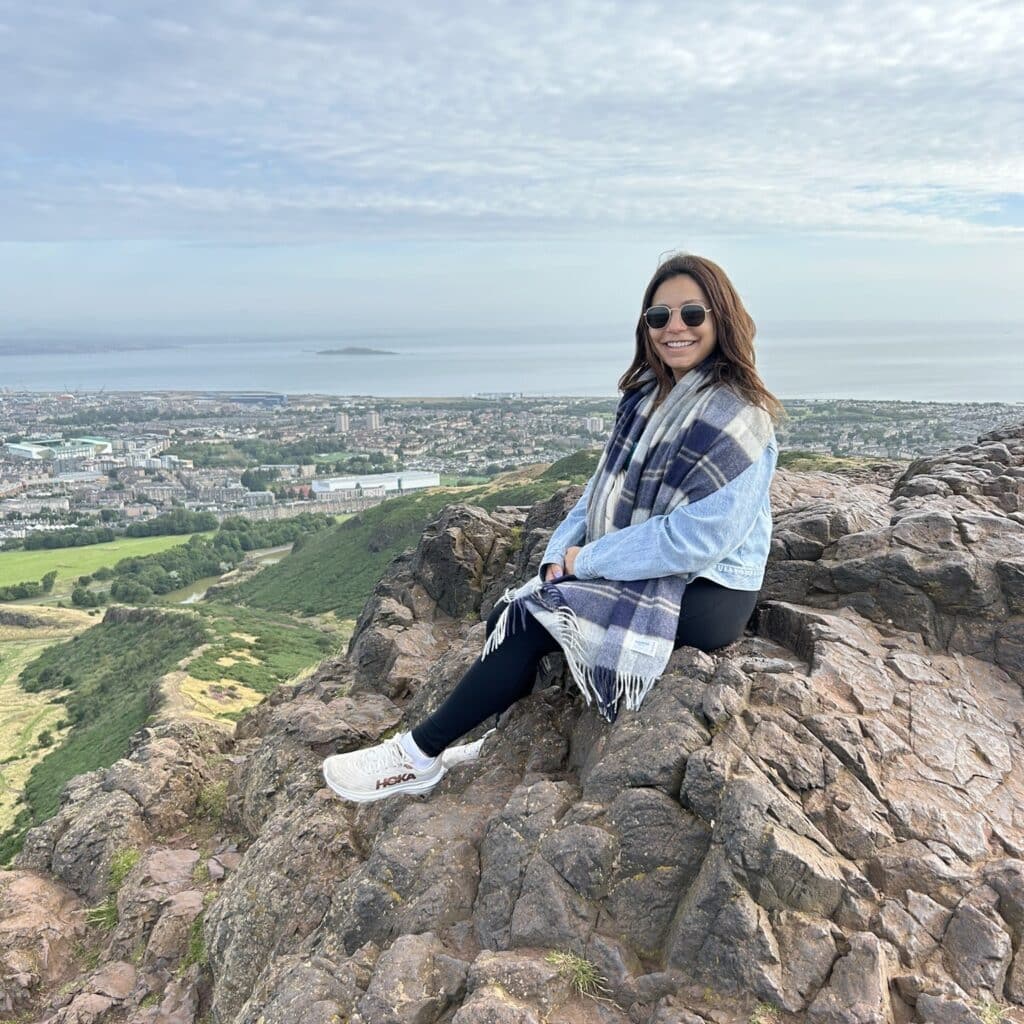 Nikki Dilluvio sitting on a rock